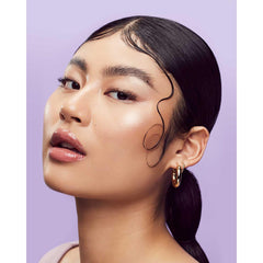 Fenty Beauty applying edge-control gel on hairline for a clean finish.