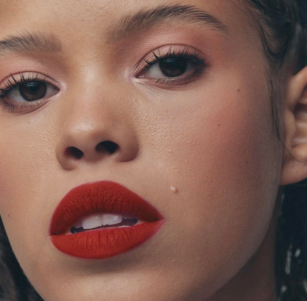 Doefoot applicator shown delivering precise color on Fenty Icon Velvet Lipstick HBIC.