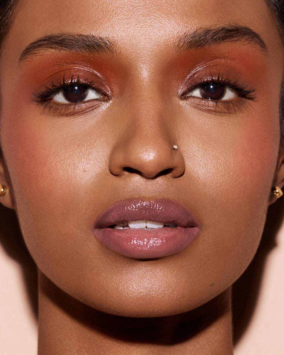 Fenty Glow lip color swatch on lips with long-lasting shine and moisture.