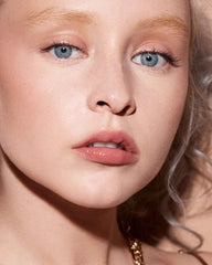 Fenty Beauty Gloss Bomb Color Drip Lip Cream tube application reveals creamy texture.