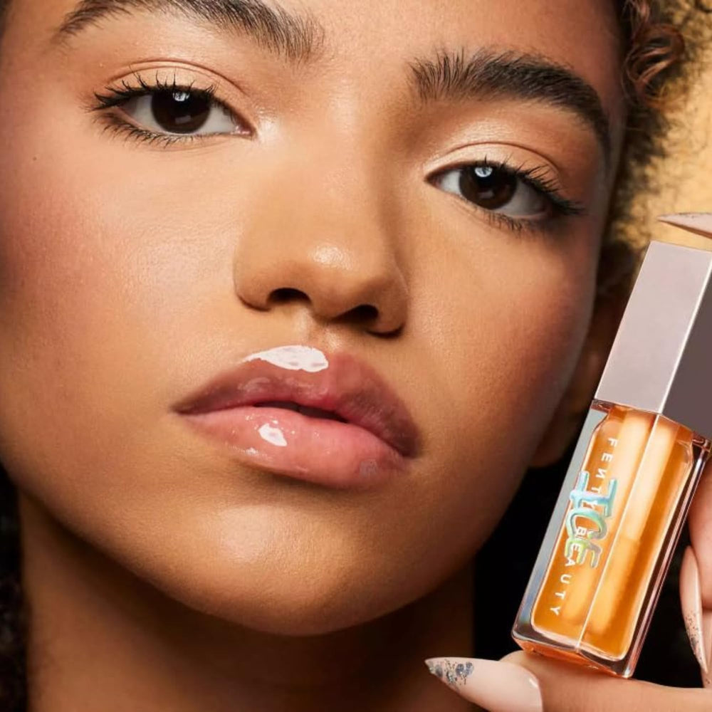 Fenty Beauty Gloss Bomb Ice Melon Chillz tube applying minty, refreshing lip luminizer.