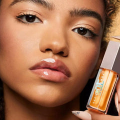 Fenty Beauty Gloss Bomb Ice Melon Chillz tube applying minty, refreshing lip luminizer.