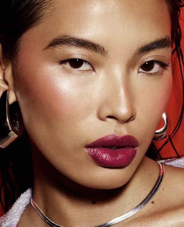 Fenty Beauty Poutsicle swatch reveals Fuchsia Wife sheer tint and shine.