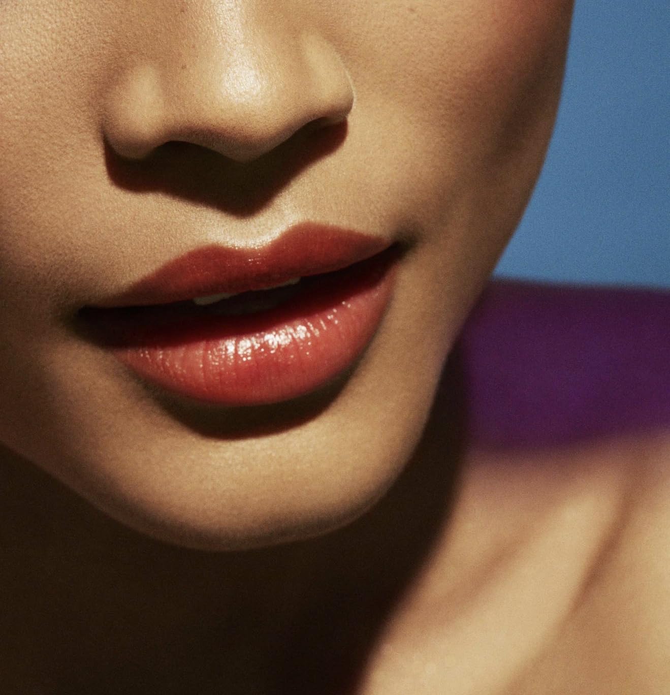 Fenty Beauty Poutsicle Zesty Bestie lip application close-up highlights smooth glossy finish