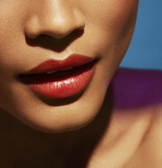 Fenty Beauty Poutsicle Zesty Bestie lip application close-up highlights smooth glossy finish