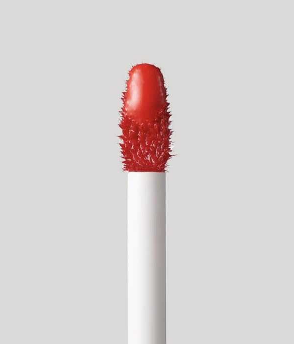 Fenty Beauty Poutsicle Zesty Bestie swatch-on-lip shows coral shade with gloss