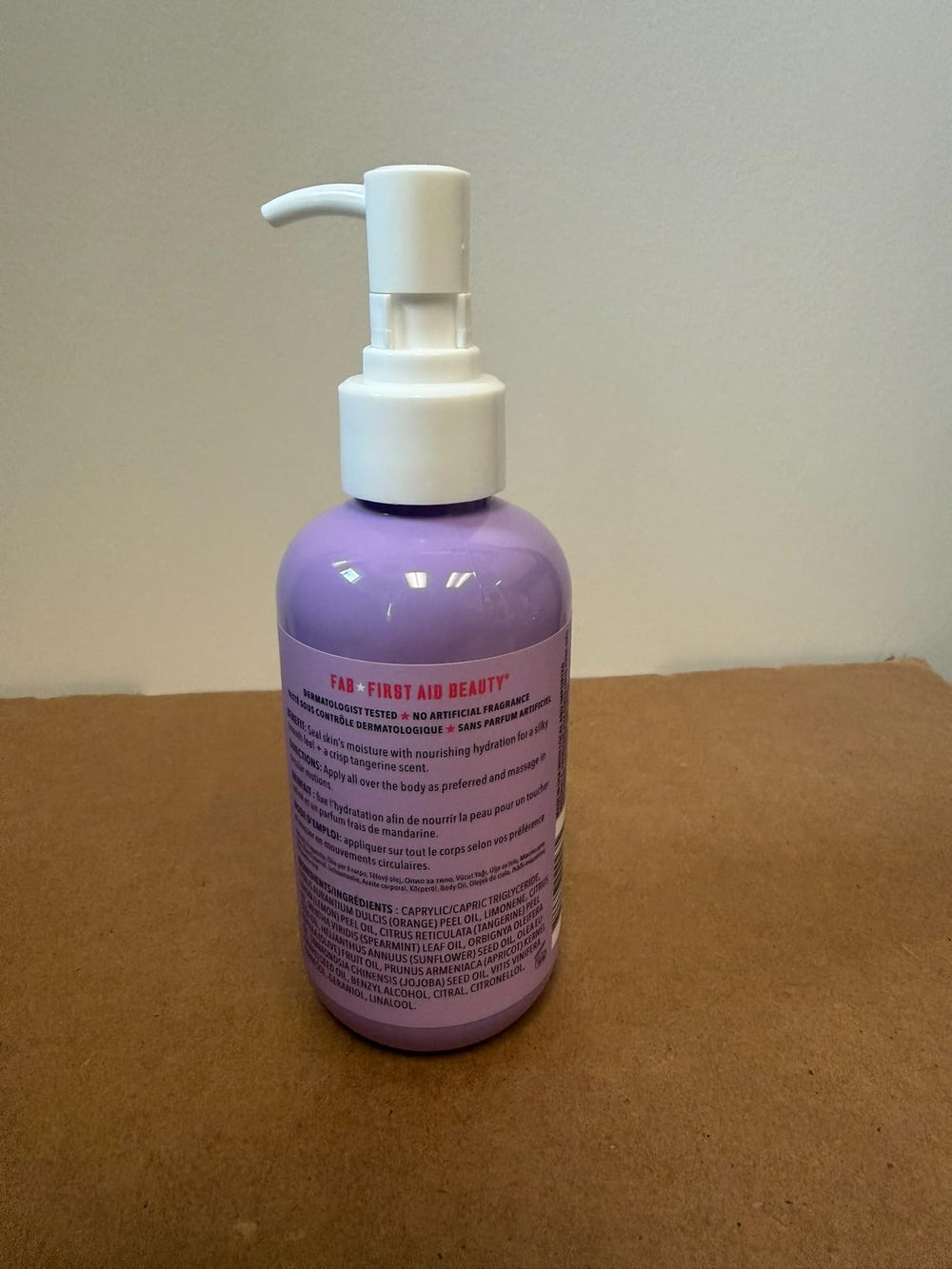 Open bottle releases crisp tangerine aroma from First Aid Beauty oil