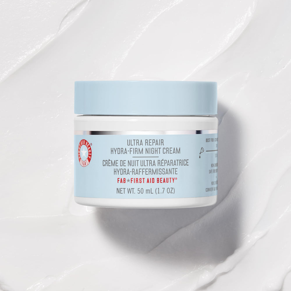First Aid Beauty night-cream swirl on finger highlights creamy, buttery texture ready for routine.