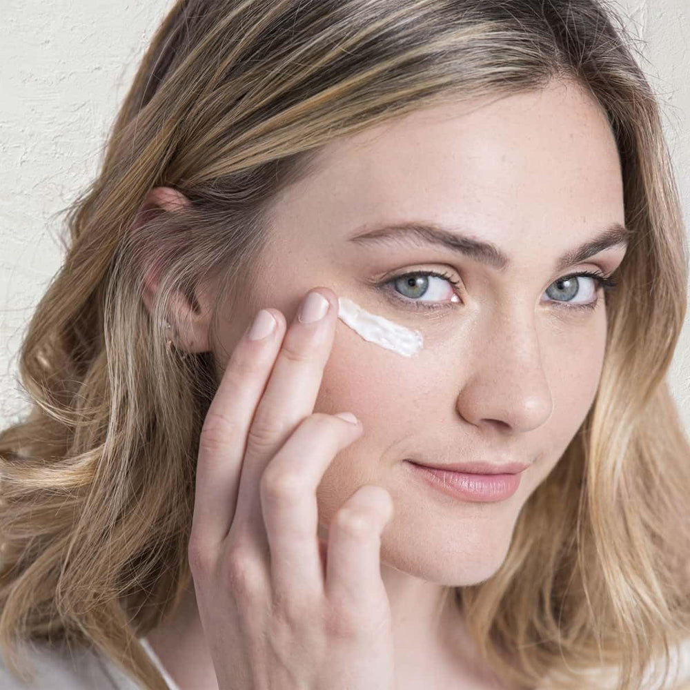 Fleur & Bee eye cream application shows easy daily dab for refreshed eyes.