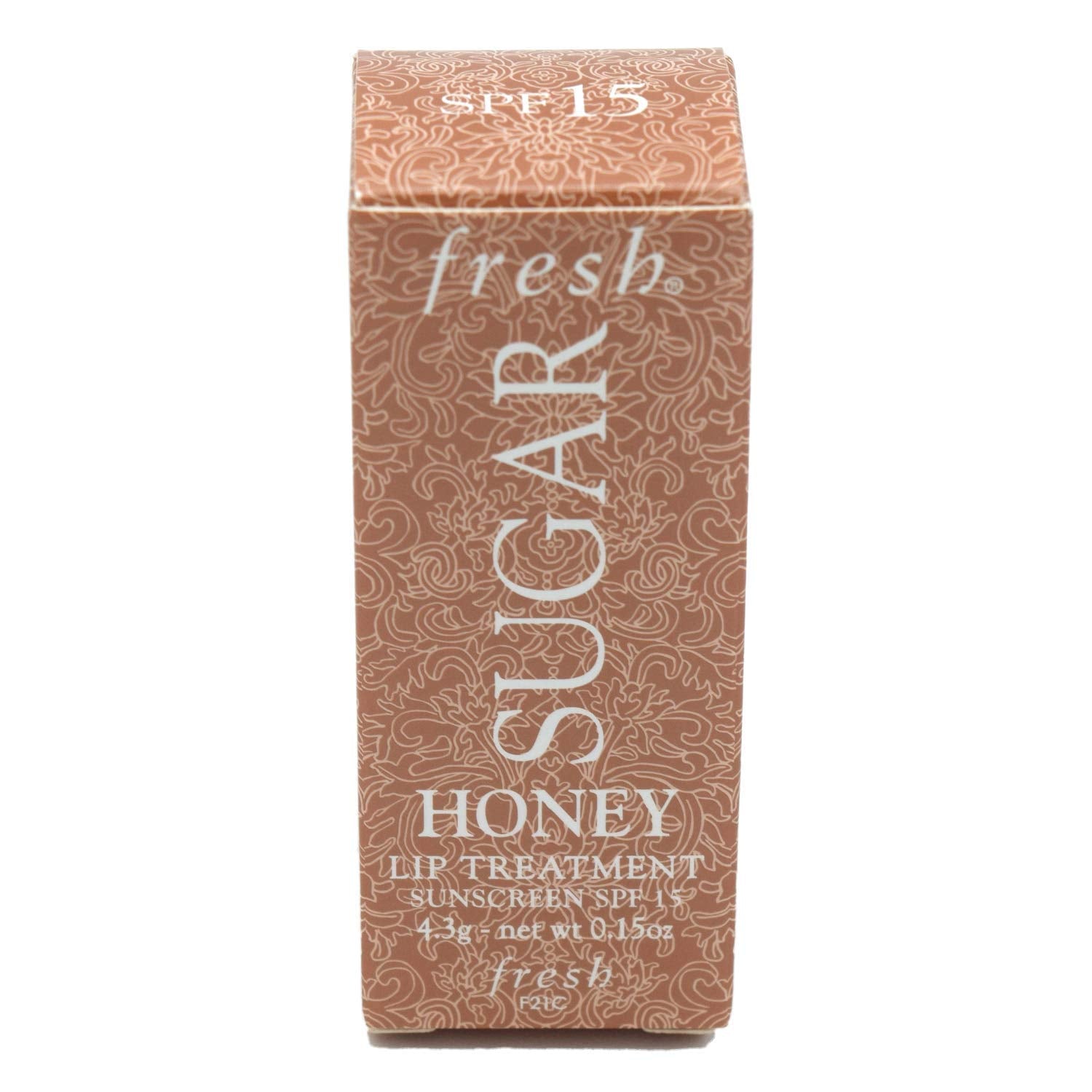Fresh Sugar Honey Tinted Lip Treatment bottle in sunlight highlights SPF 15 protection.