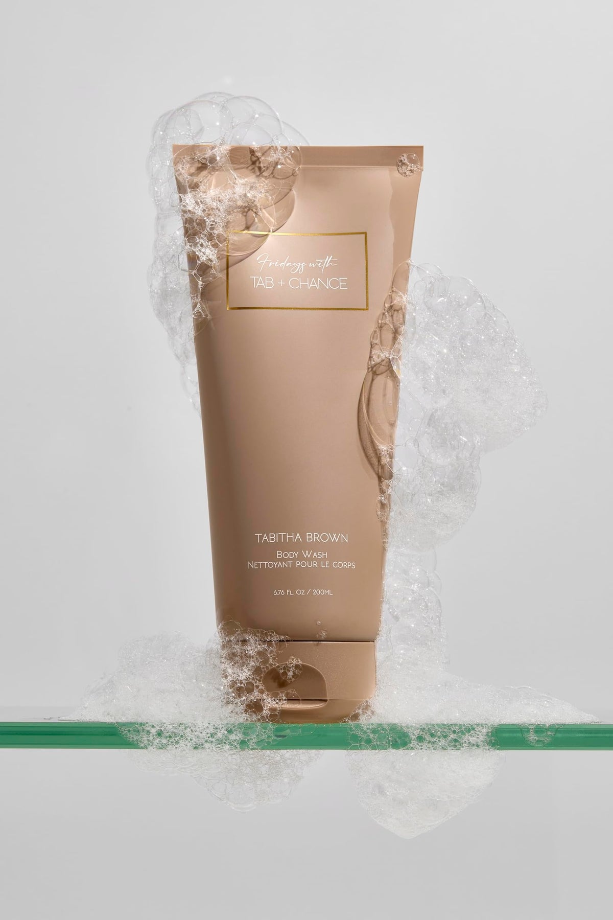FRIDAYS Her Business Body Wash bottle being poured, releasing a mood-lifting fragrance.