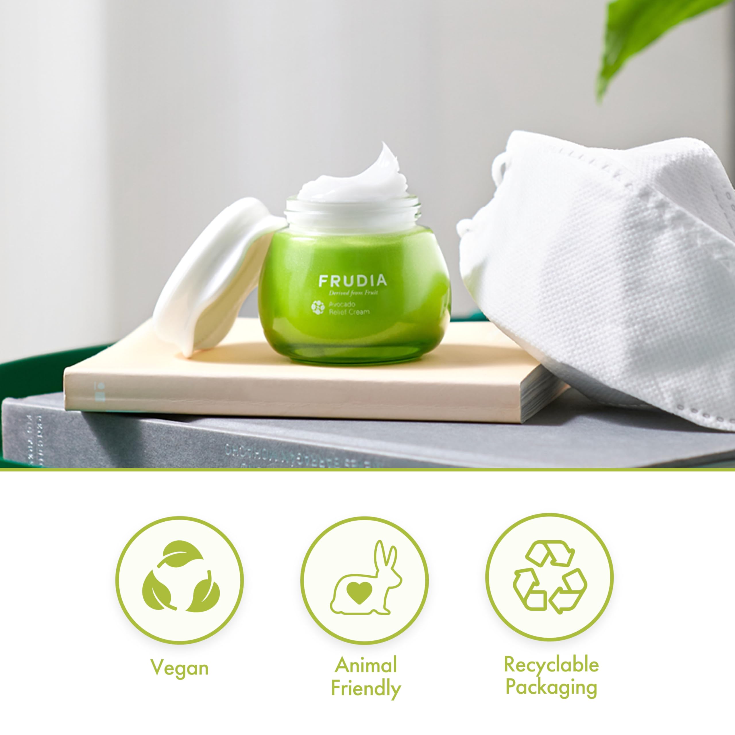 Applying FRUDIA Avocado Relief Face Cream on cheek for gentle hydration