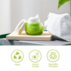 Applying FRUDIA Avocado Relief Face Cream on cheek for gentle hydration