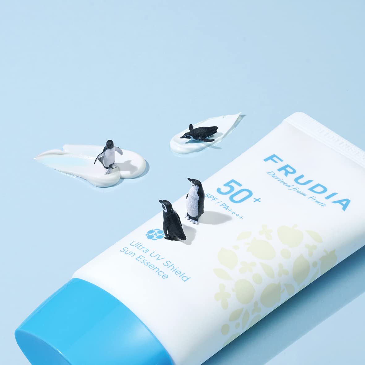 FRUDIA Welcos Sun Block Day Cream Essence under sunlight highlights natural radiance and protection.