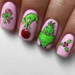 FUKIDOG Christmas nails in pink square with green-haired monster for festive flair.