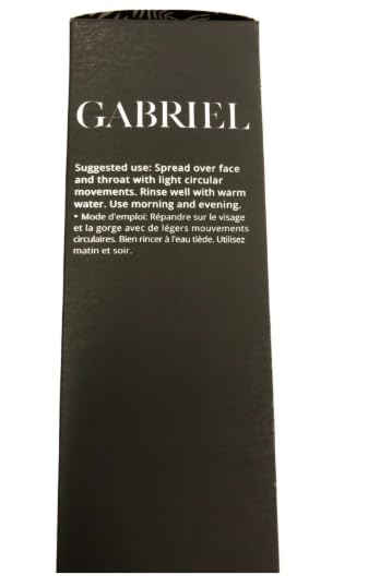 Hands applying Gabriel Cosmetics cleanser to face with soft circular motions.