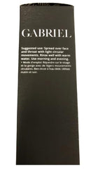 Hands applying Gabriel Cosmetics cleanser to face with soft circular motions.