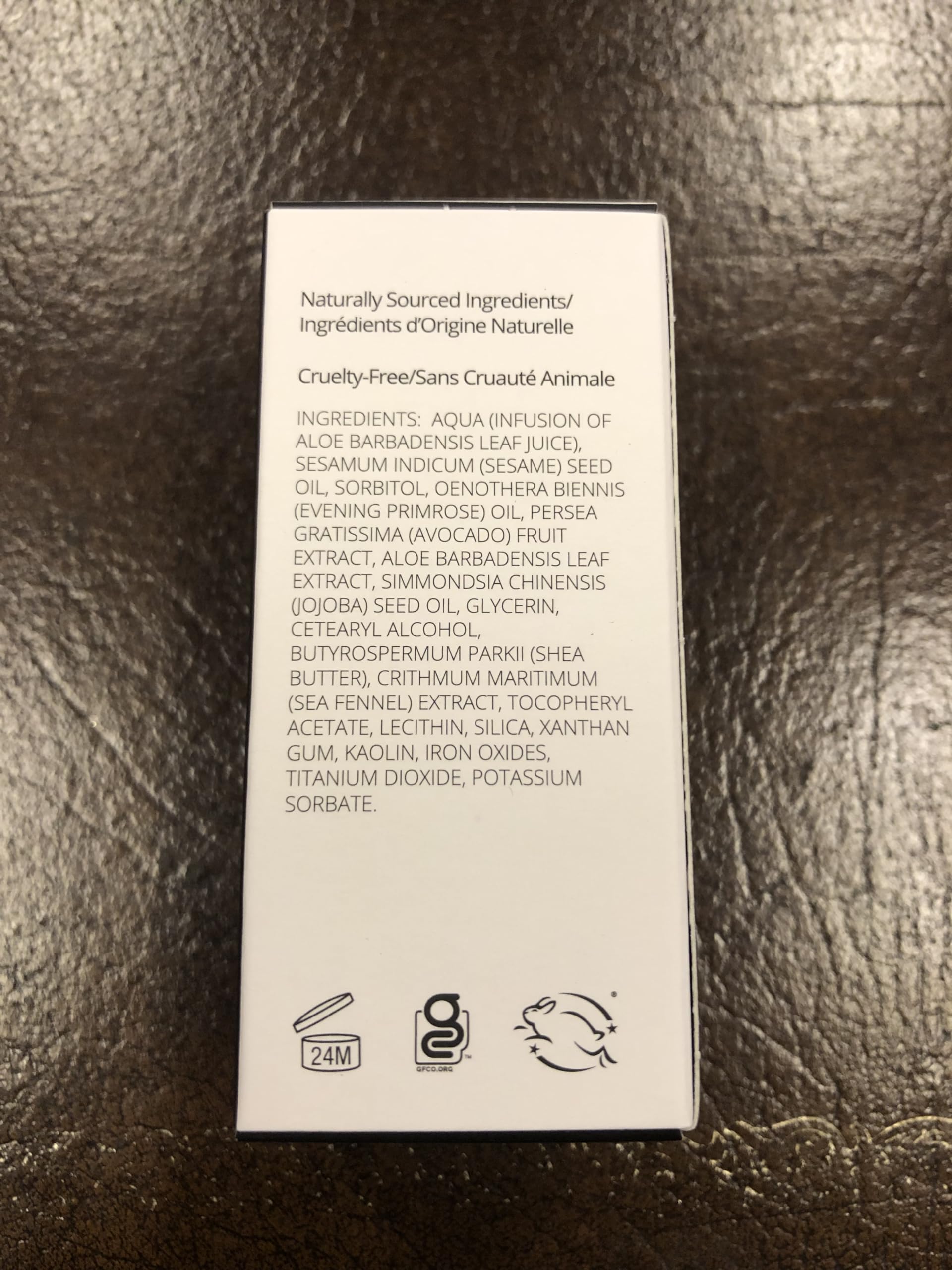 Applying Gabriel Cosmetics liquid foundation with fingers for a balanced finish.