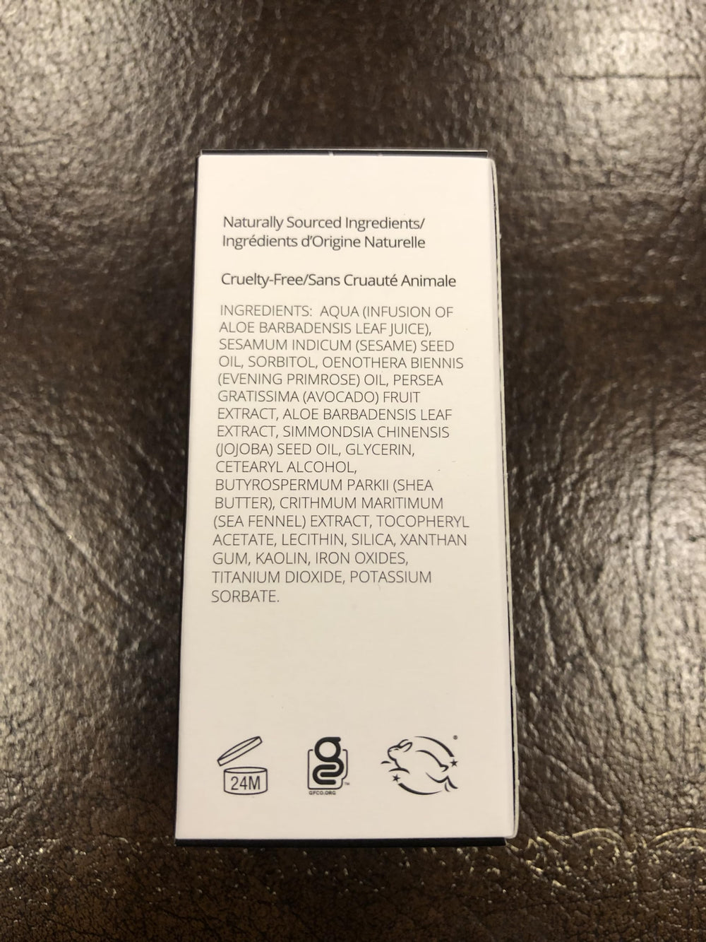 Applying Gabriel Cosmetics liquid foundation with fingers for a balanced finish.
