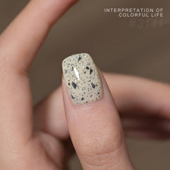 GAOY eggshell speckle dots closeup – chic black speckles on nails.