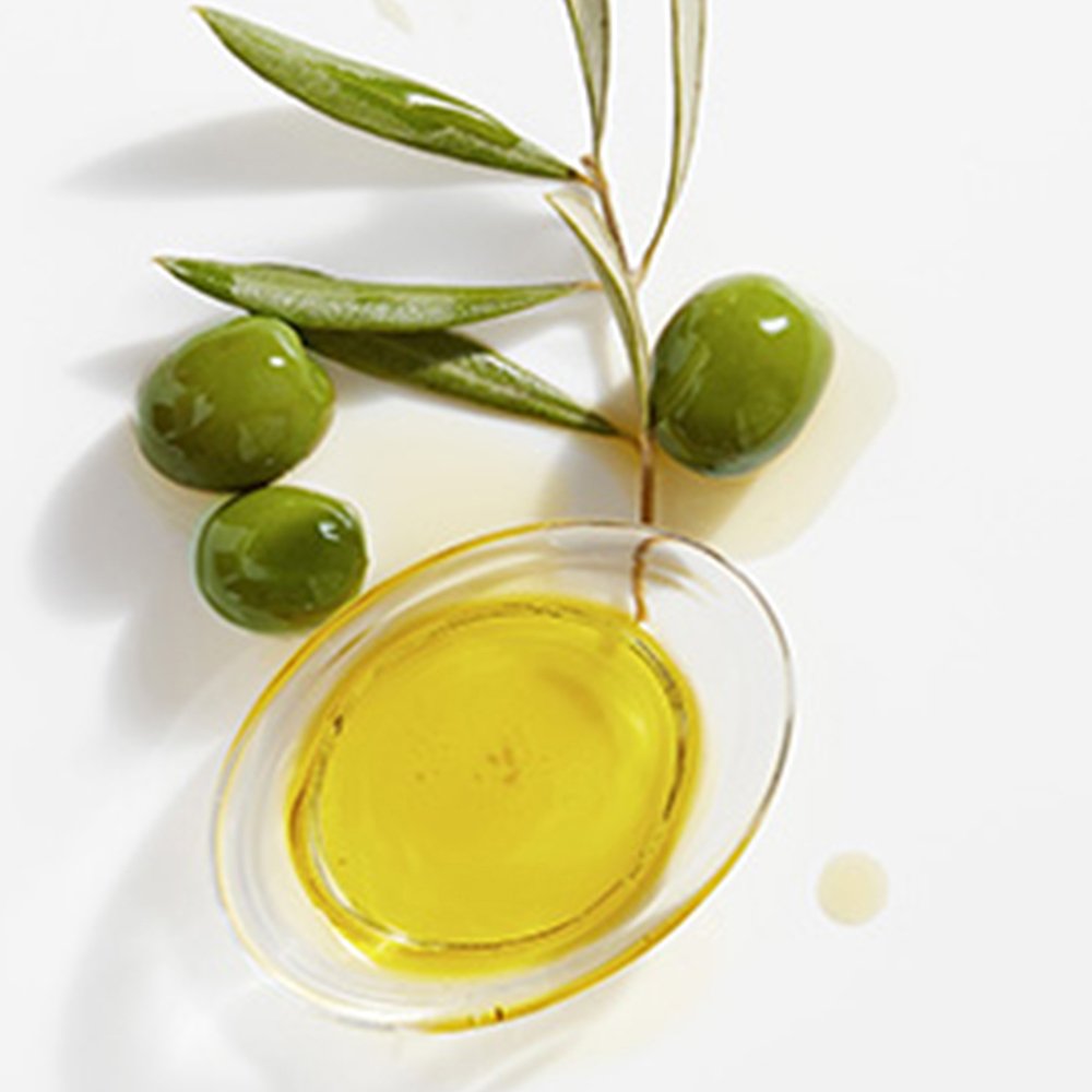 Garnier Whole Blends Legendary Olive shampoo lather demonstrates gentle cleansing.