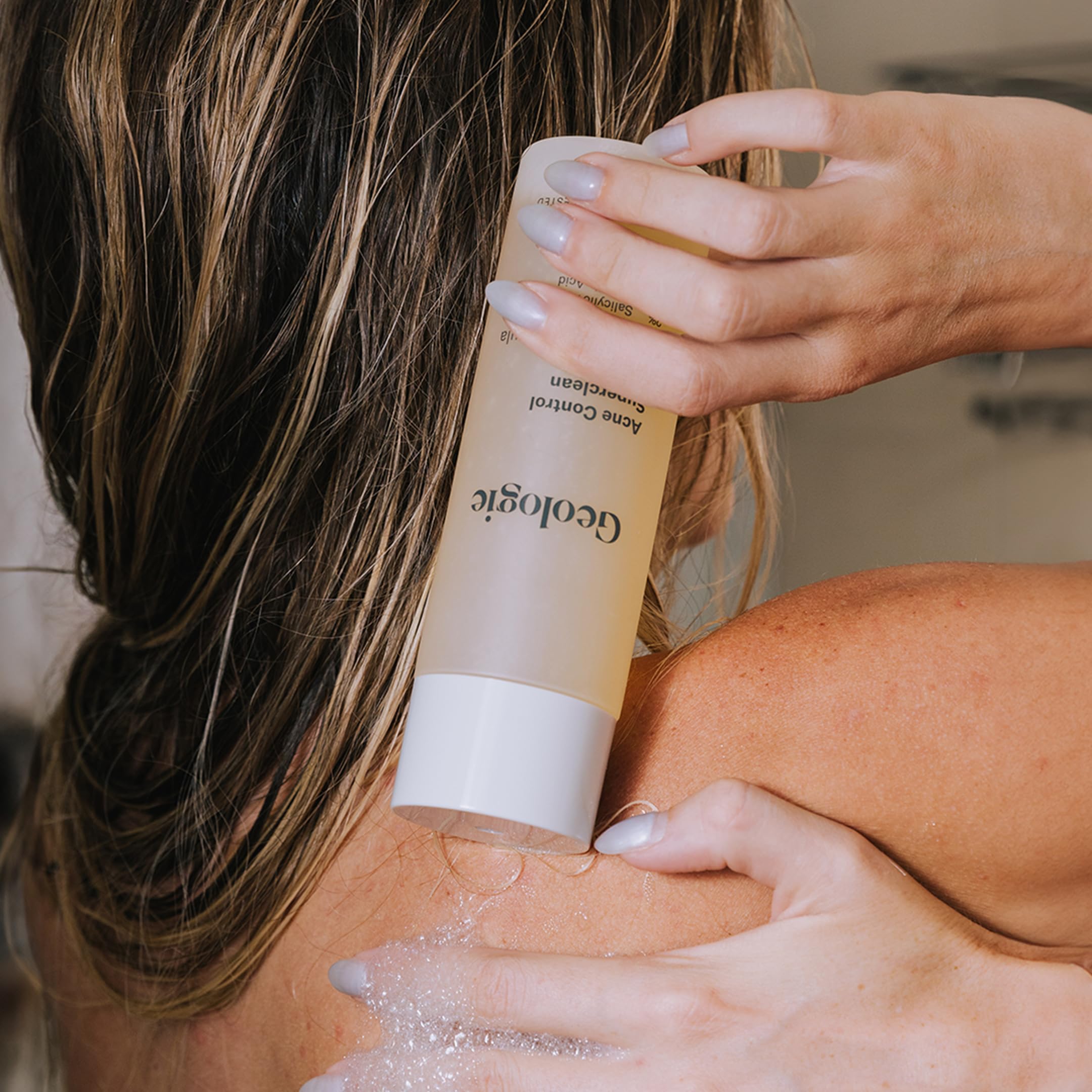 Geologie Acne Control Body Wash label closeup highlights 2% salicylic and 1.5% glycolic acids.