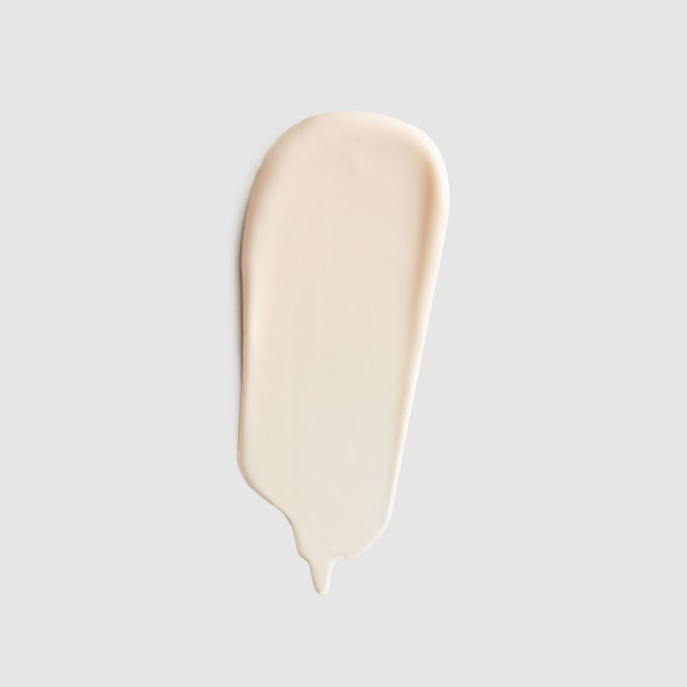 Cream on body with soft glow suggests even tone and nourished skin.