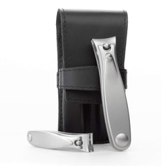 Germanikure nail clippers set in black leather case for travel grooming.