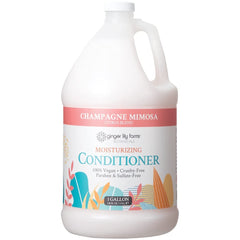 Ginger Lily Farms Champagne Mimosa conditioner bottle pour nourishes and smooths hair.