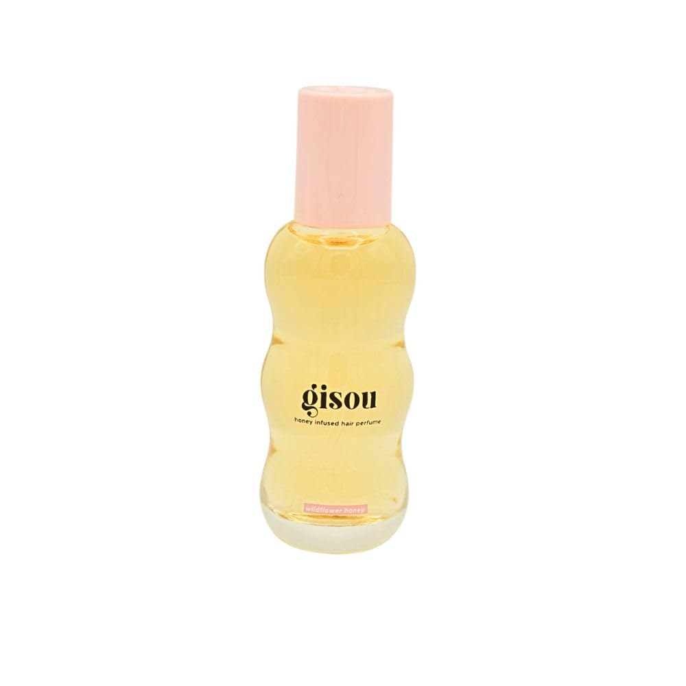 Gisou Honey Infused Hair Oil being applied to hair lengths