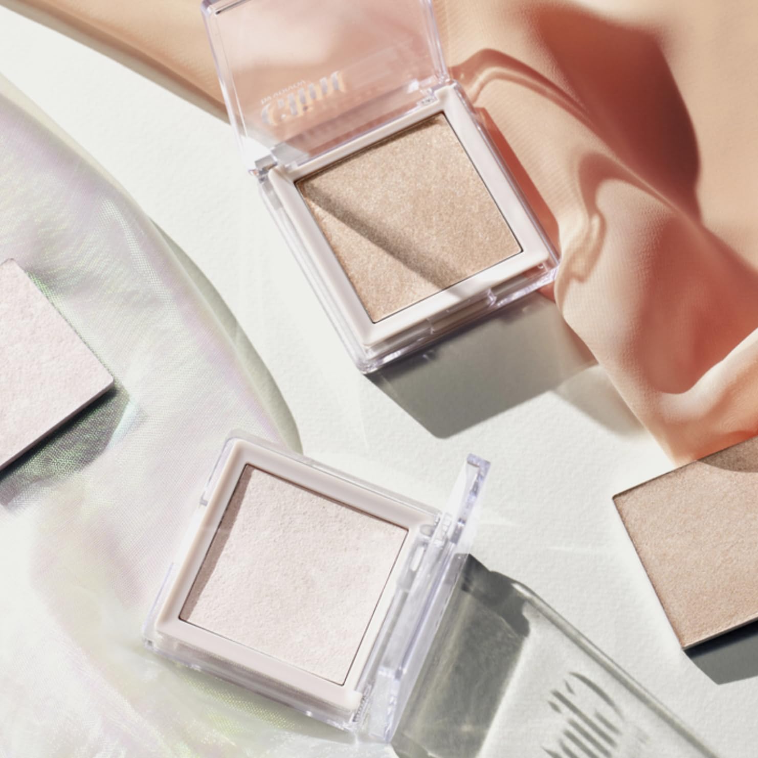 Shade Milky Moon from Glint Dewy Highlighter for soft pink-lit glow.