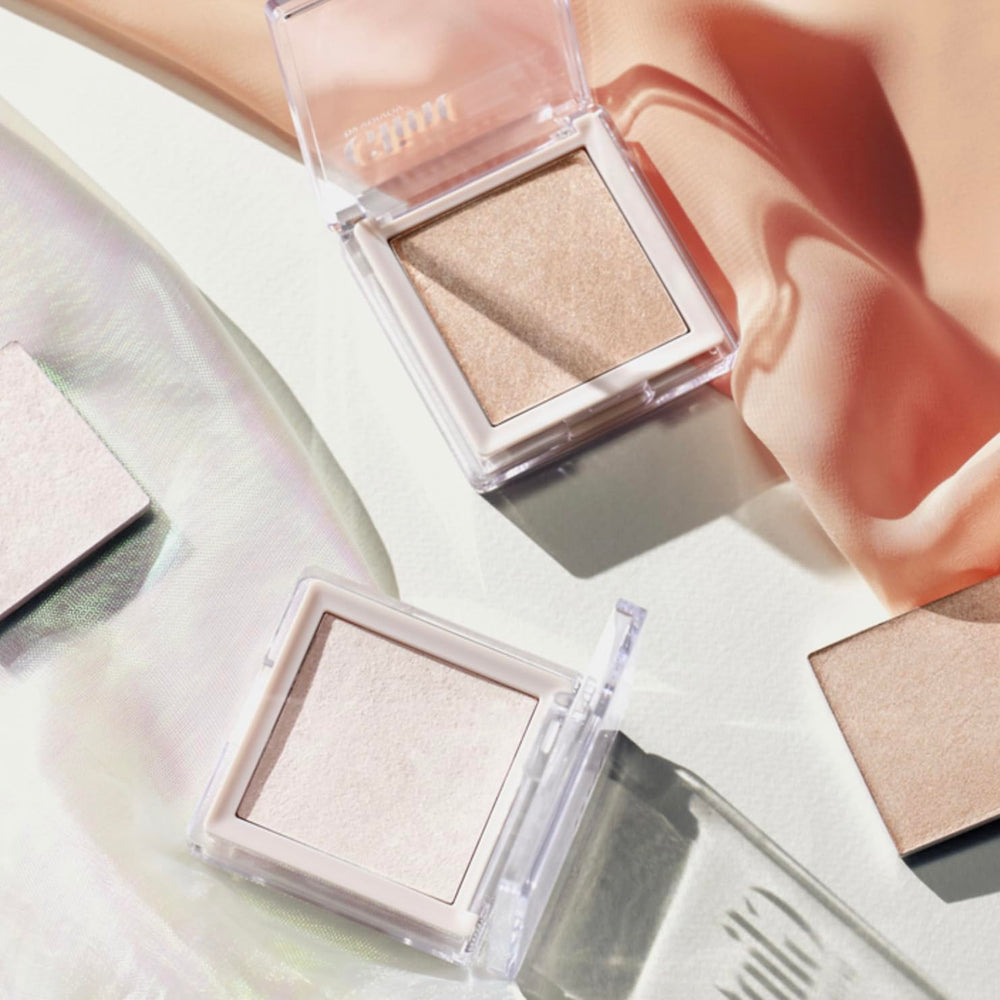 Shade Milky Moon from Glint Dewy Highlighter for soft pink-lit glow.