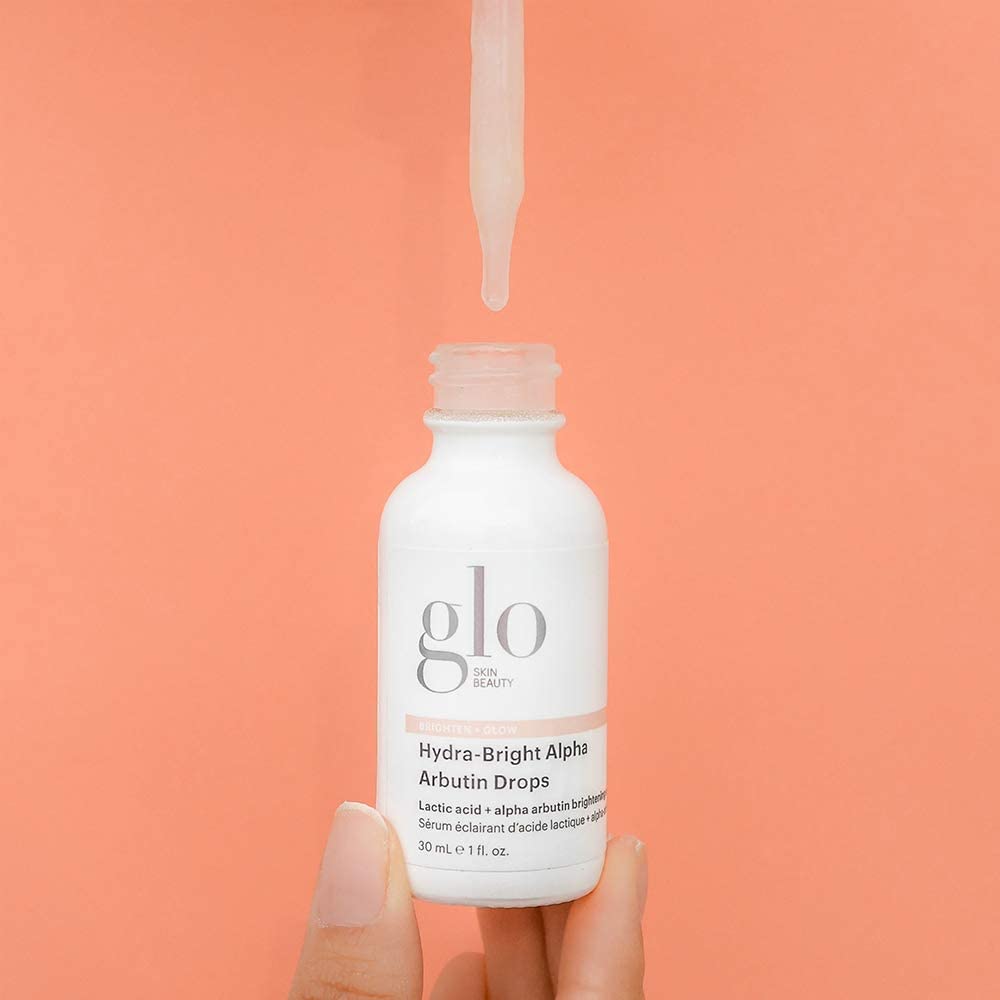 Glo Skin Beauty Alpha Arbutin Drops on a bathroom shelf.