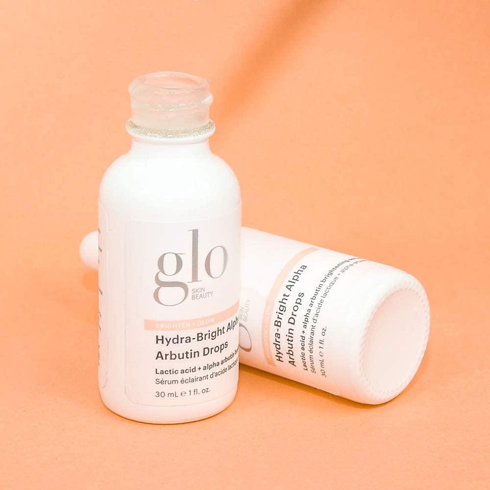 Glo Skin Beauty routine setup with skincare serums nearby.