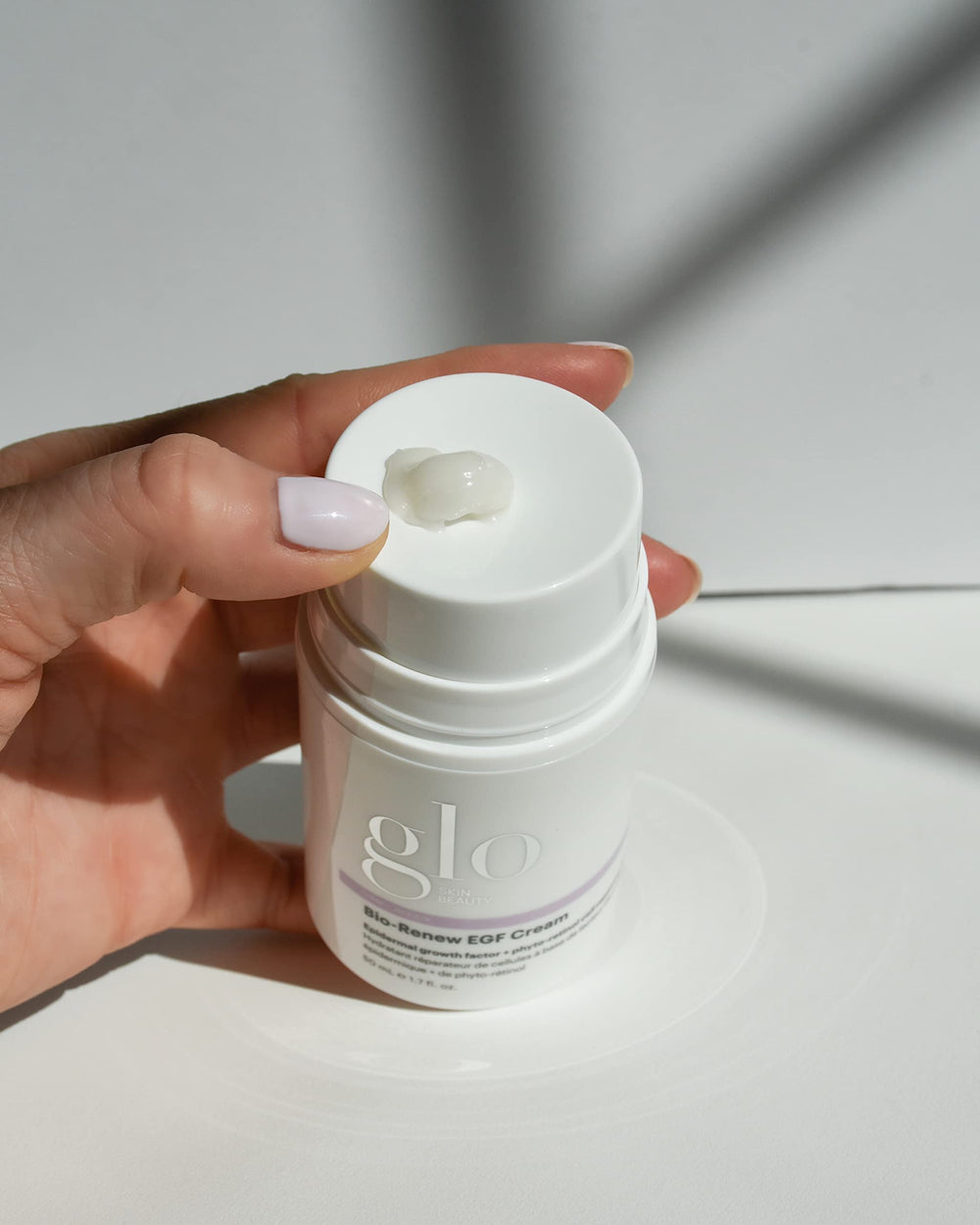 Glo Skin Beauty Bio-Renew EGF Cream being spread across skin for absorption.