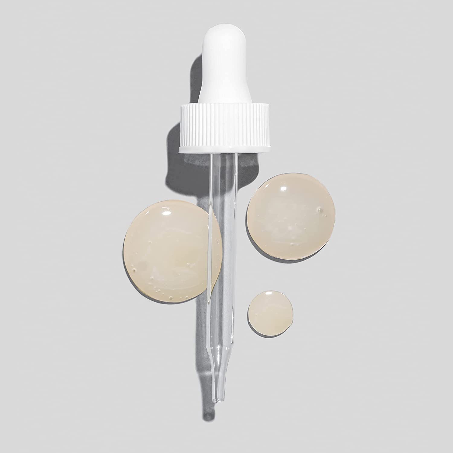 Glo Skin Beauty Hydra-Bright Drops on skin delivering subtle radiance.