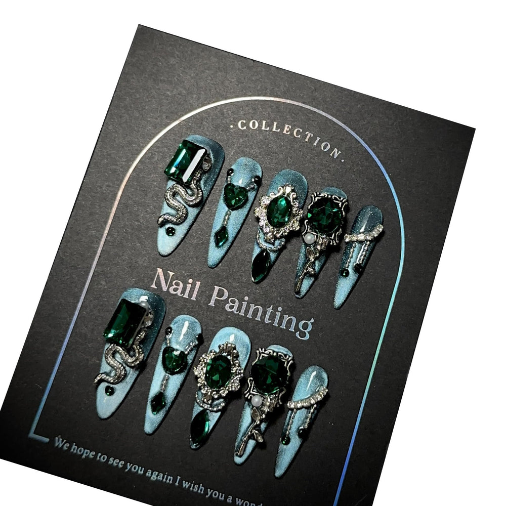 GLORS blue glitter Medusa-inspired long-stiletto nails with rhinestones for dramatic at-home manicure.