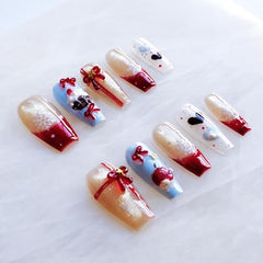 GLORS nails show red cat eye effect and apple motifs for holidays