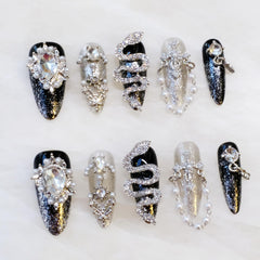 GLORS luxury long almond nails with serpent motif for dramatic evening glam.