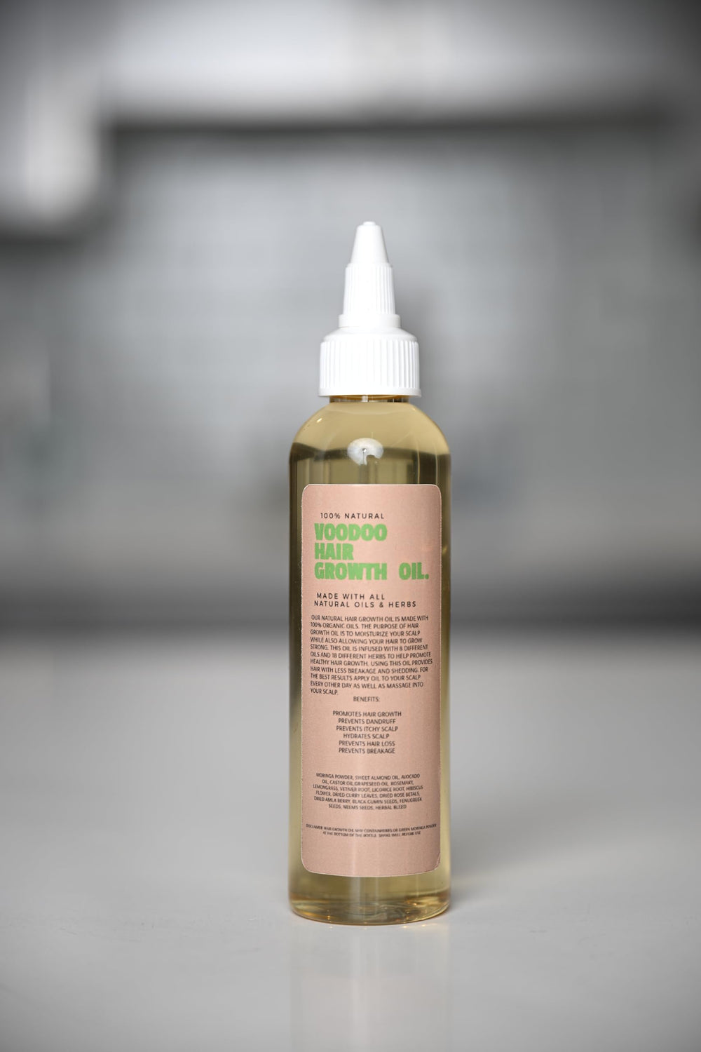 Glossed by Nae Voodoo Hair Growth Oil in-use at vanity for routine care