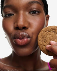 Glossier Balm Dotcom Gingersnap with toasted taupe tint enhances natural lip color.