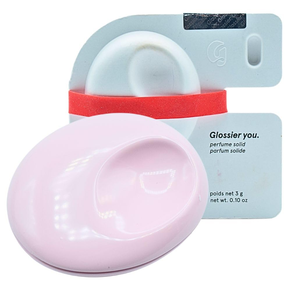 Glossier You Solid Perfume compact close-up shows portable pink enamel design.