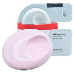 Glossier You Solid Perfume compact close-up shows portable pink enamel design.
