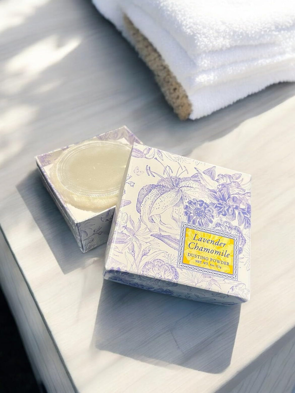 Greenwich Bay Lavender Chamomile Dusting Powder being lightly dusted on skin after bath for smooth feel
