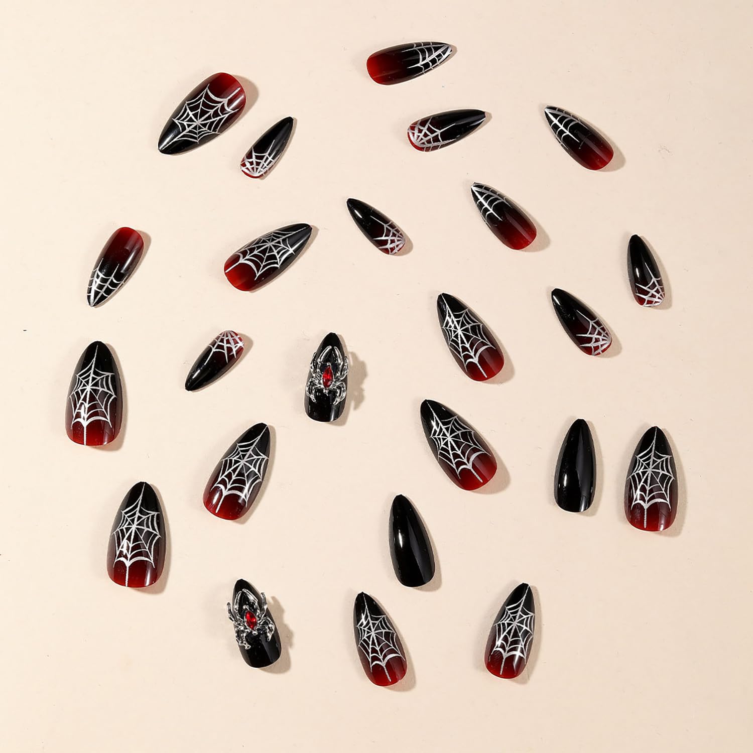 GRITOSE 3D spider accents on luxe black and red nails.