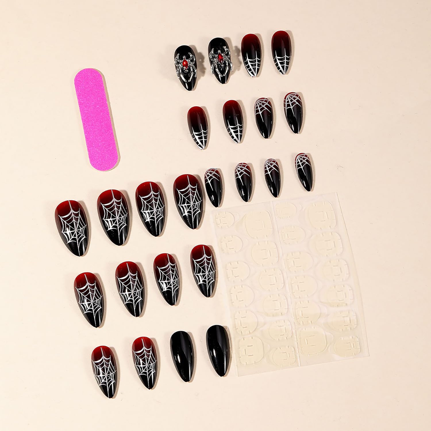 GRITOSE spider web design nails with rhinestones for a bold Halloween look.
