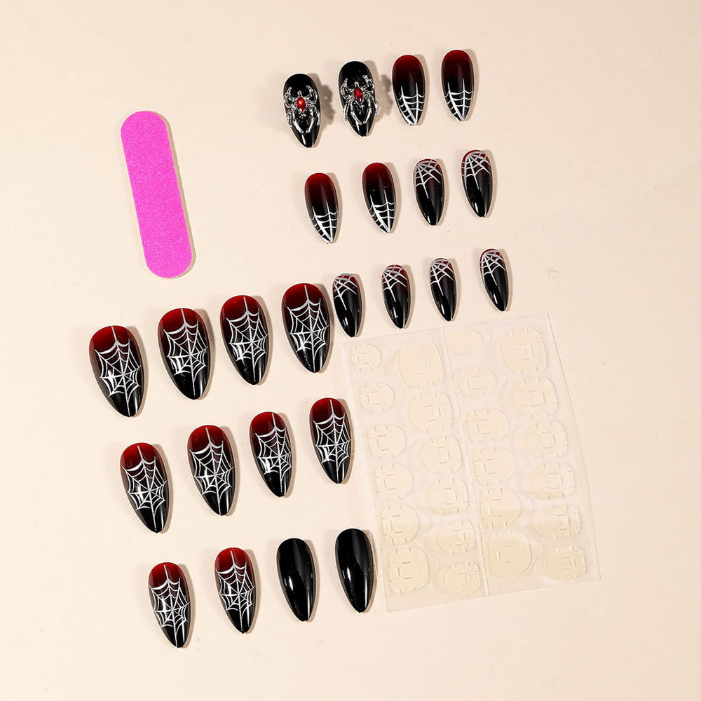 GRITOSE spider web design nails with rhinestones for a bold Halloween look.