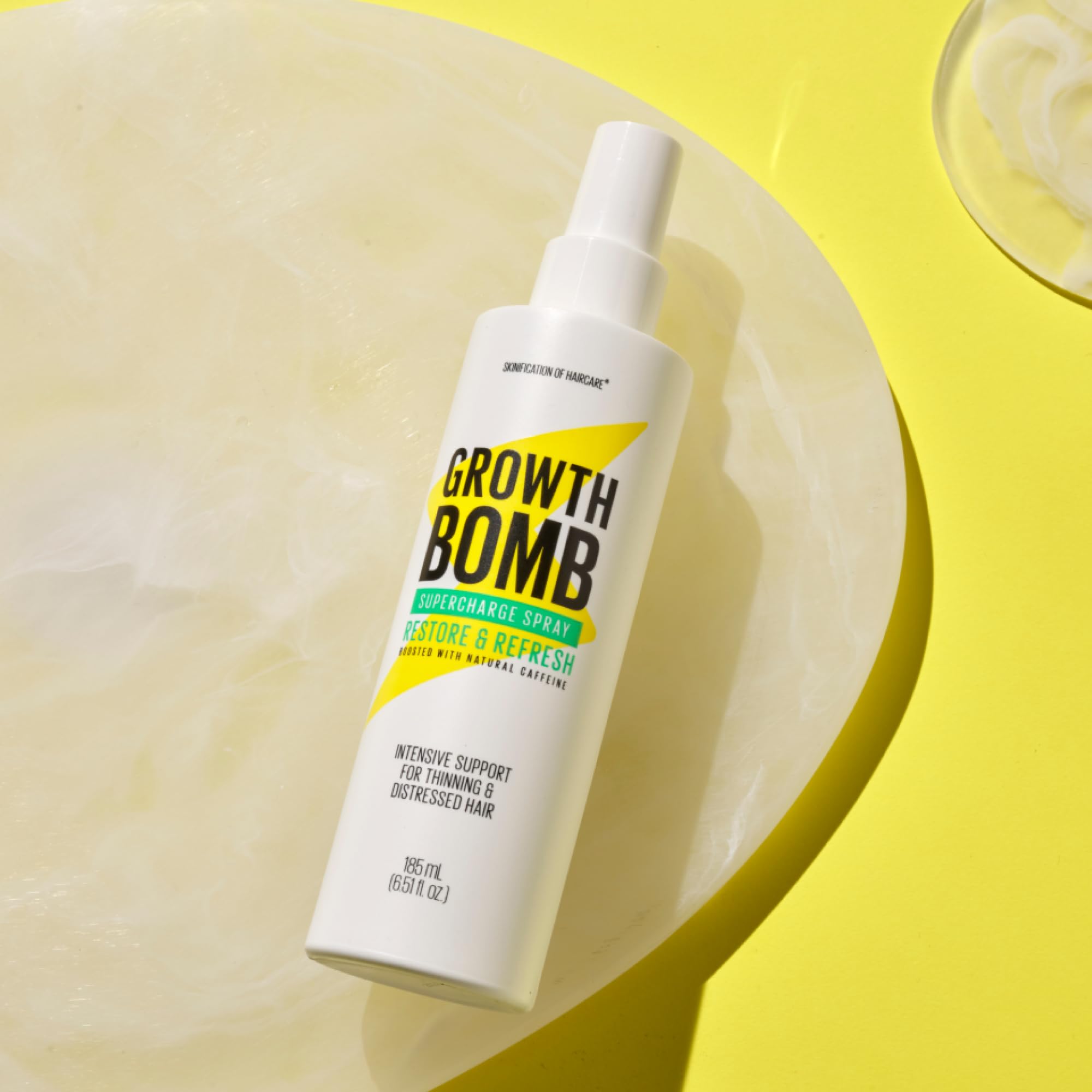 Growth Bomb Supercharge Spray damp hair application promotes lightweight hydration.