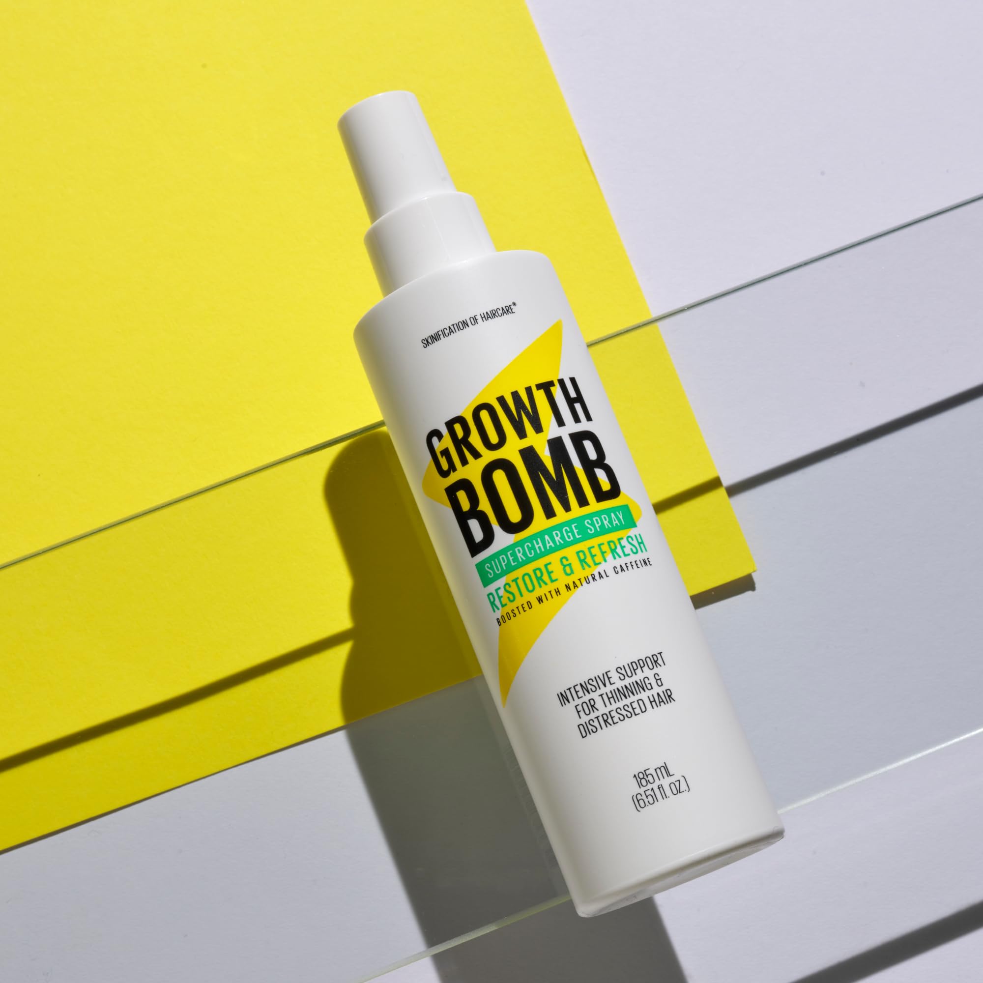 Growth Bomb Supercharge Spray packaging on display signals plant-powered care.