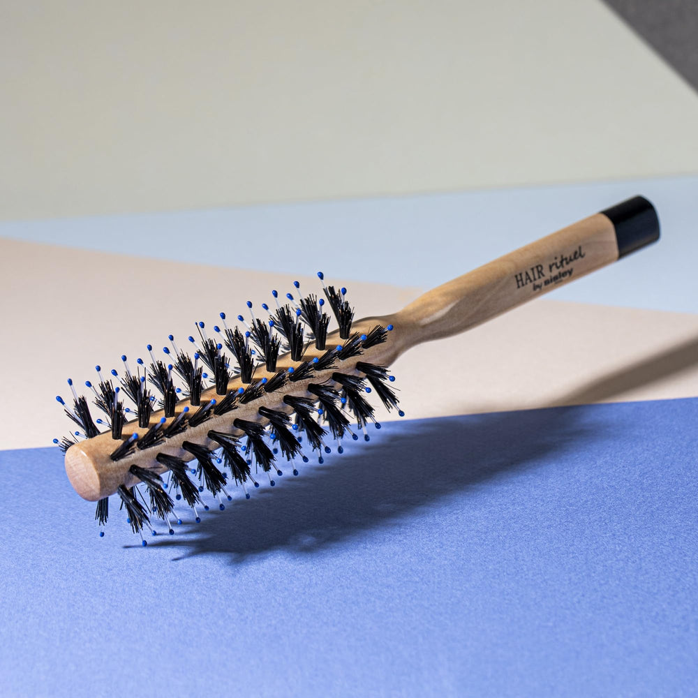 Hair Rituel round brush shapes bangs and short-to-medium hair for styling.